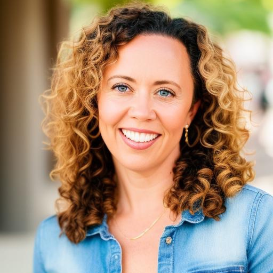 A photo of Diana, a white woman with blonde curly hair, smiling at the camera
