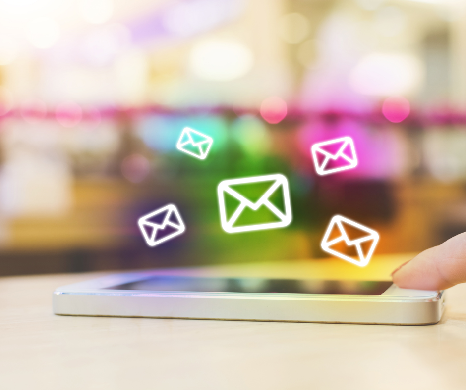 A photo of a phone with neon illustrations of emails above the phone